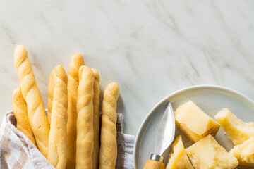 Grissini sticks and parmesan cheese. Traditional italian food.
