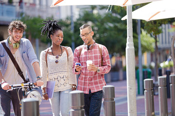 Friends walking together on city street