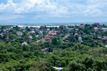 Summer Russian landscape, cottages on the bank of the Amur River
