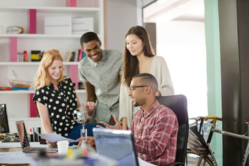 People examining model in office