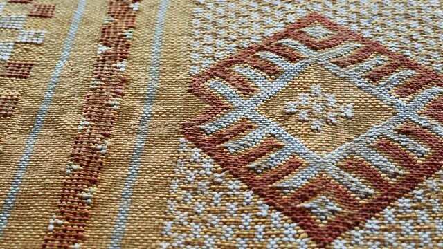 Handmade, traditional, Moroccan cactus silk (Sabra silk) rug, carpet. Closeup detail of abstract geometric patterns, handwoven.