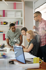 People examining model in office