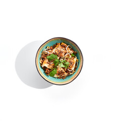 Pan asian traditional dish - fried rice with egg, vegetables, and squid. Indian wok with rice, egg and kalmar on white background. Nasi goreng with calamari on isolated background with shadows.