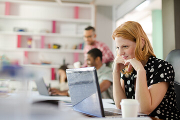 Woman working at laptop in office