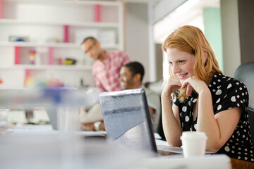Woman working at laptop in office