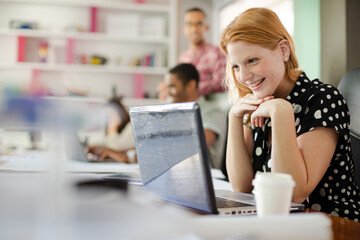 Woman working at laptop in office