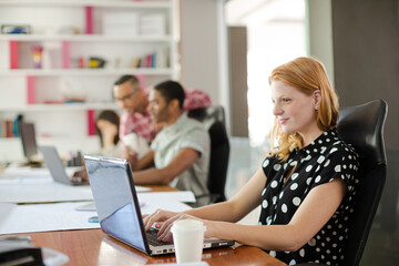 Woman working at laptop in office