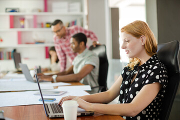 Woman working at laptop in office