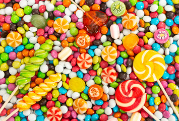 Fototapeta na wymiar Colorful lollipops and different colored round candy.
