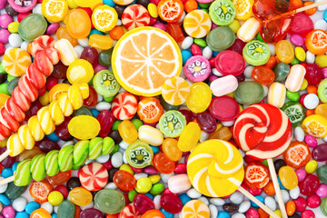 Fototapeta na wymiar Colorful lollipops and different colored round candy.