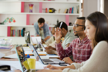 People working at conference table in office