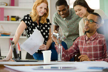 People examining model in office