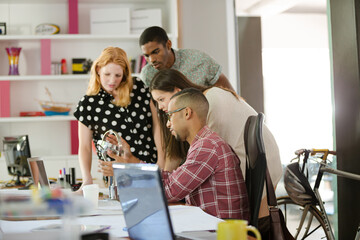 People examining model in office