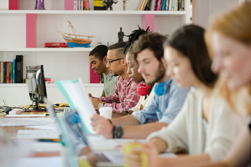 People working at conference table in office