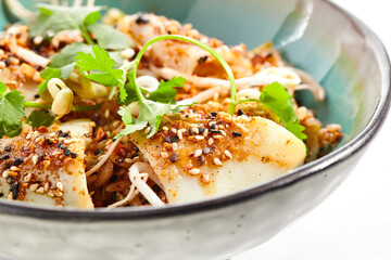 Pan asian traditional dish - fried rice with egg, vegetables, and squid. Indian wok with rice, egg and kalmar on white background. Nasi goreng with calamari on isolated background with shadows. © Ryzhkov