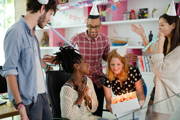 People celebrating birthday in office