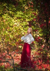 Autumn collection, lady in white shirt and long burgundy skirt. Outdoor portrait