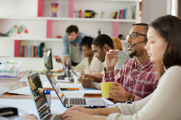People working at conference table in office