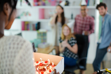 People celebrating birthday in office