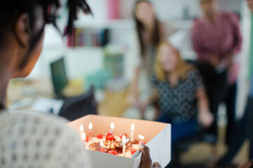 People celebrating birthday in office