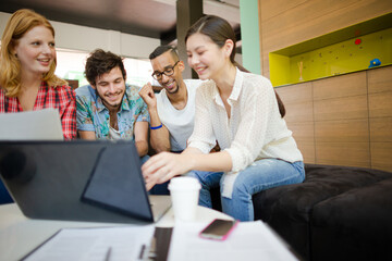 People working at laptop in office