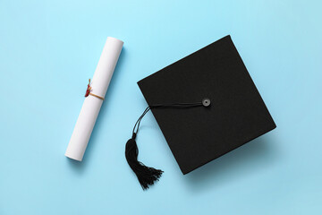 Graduation hat and diploma on color background - obrazy, fototapety, plakaty