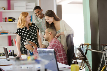 People examining model in office