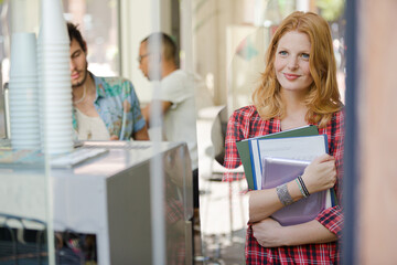 Woman carrying folders in office