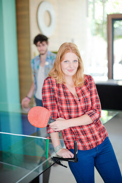 Woman posing with tennis table racket