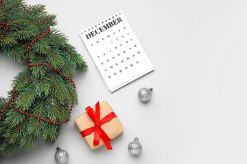Christmas composition with calendar on light background