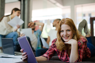 Woman using digital tablet in cafe