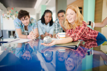 People examining miniature globe