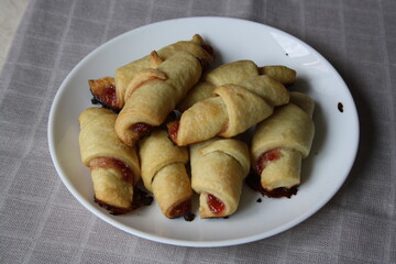 Dough rolls with jam on a plate.