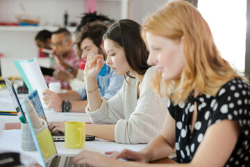 People working at conference table in office