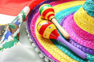 Maracas and sombrero on Mexican flag, closeup