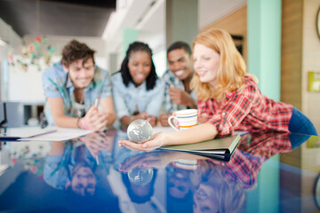 People examining miniature globe
