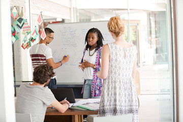 Man drawing on white board for colleagues