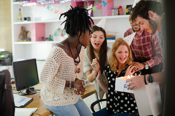 People celebrating birthday in office