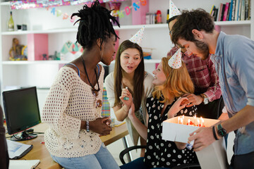People celebrating birthday in office