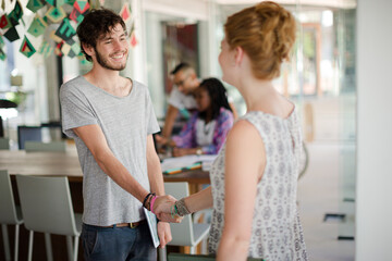 People shaking hands in office