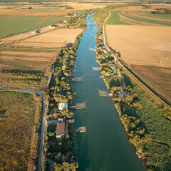 Aerial view of fishing huts on river with typical italian fishing machine, called 
