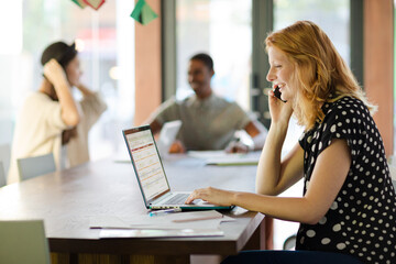 Woman working at conference table in office