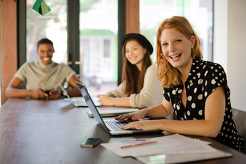 People working at conference table in office