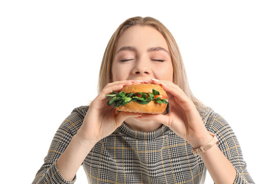 Young Woman Eating Tasty Vegan Burger On White Background