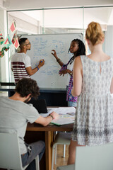 Man drawing on white board for colleagues