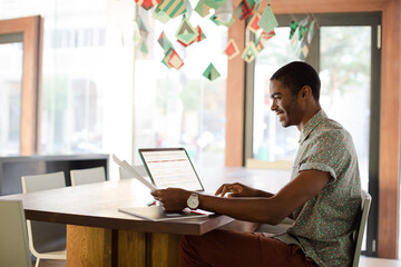 Man working on laptop at office