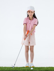 Studio shot of pretty cute long hair little Asian golfer in sport uniform and colorful cap stand posing holding golf driver on white background