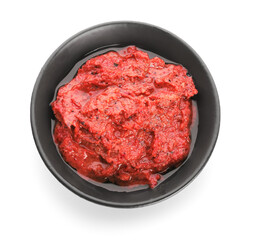 Bowl of tasty pesto sauce on white background