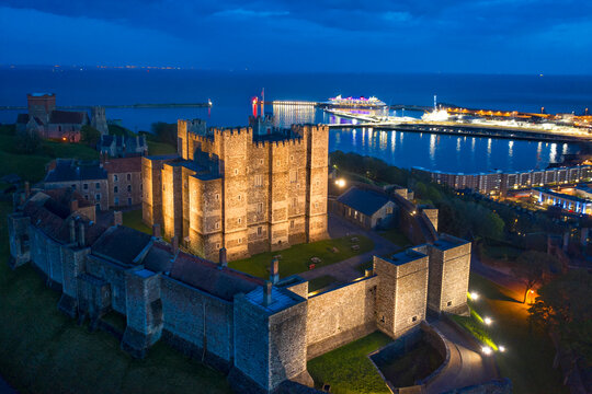 Dover, England, United Kingdom - May 10, 2021: Aerial night view of Dover castle and port.