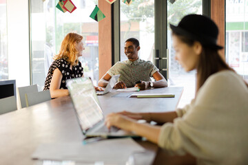 People working at conference table in office